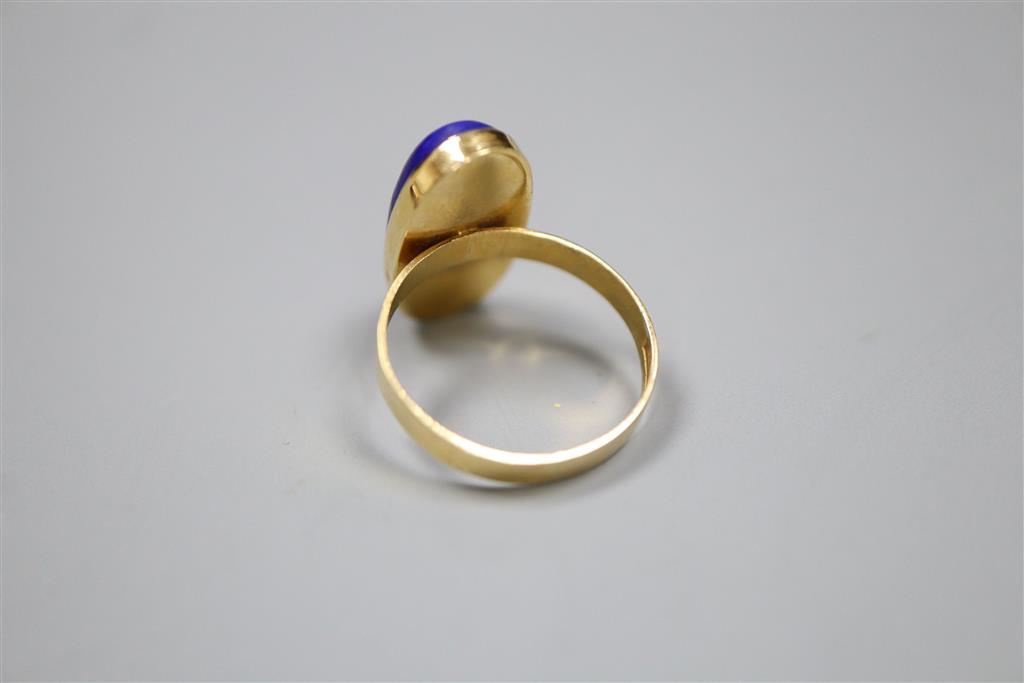 A Middle Eastern yellow metal and lapis lazuli oval dress ring, size N, and pair of matching earrings, gross 8.7 grams.